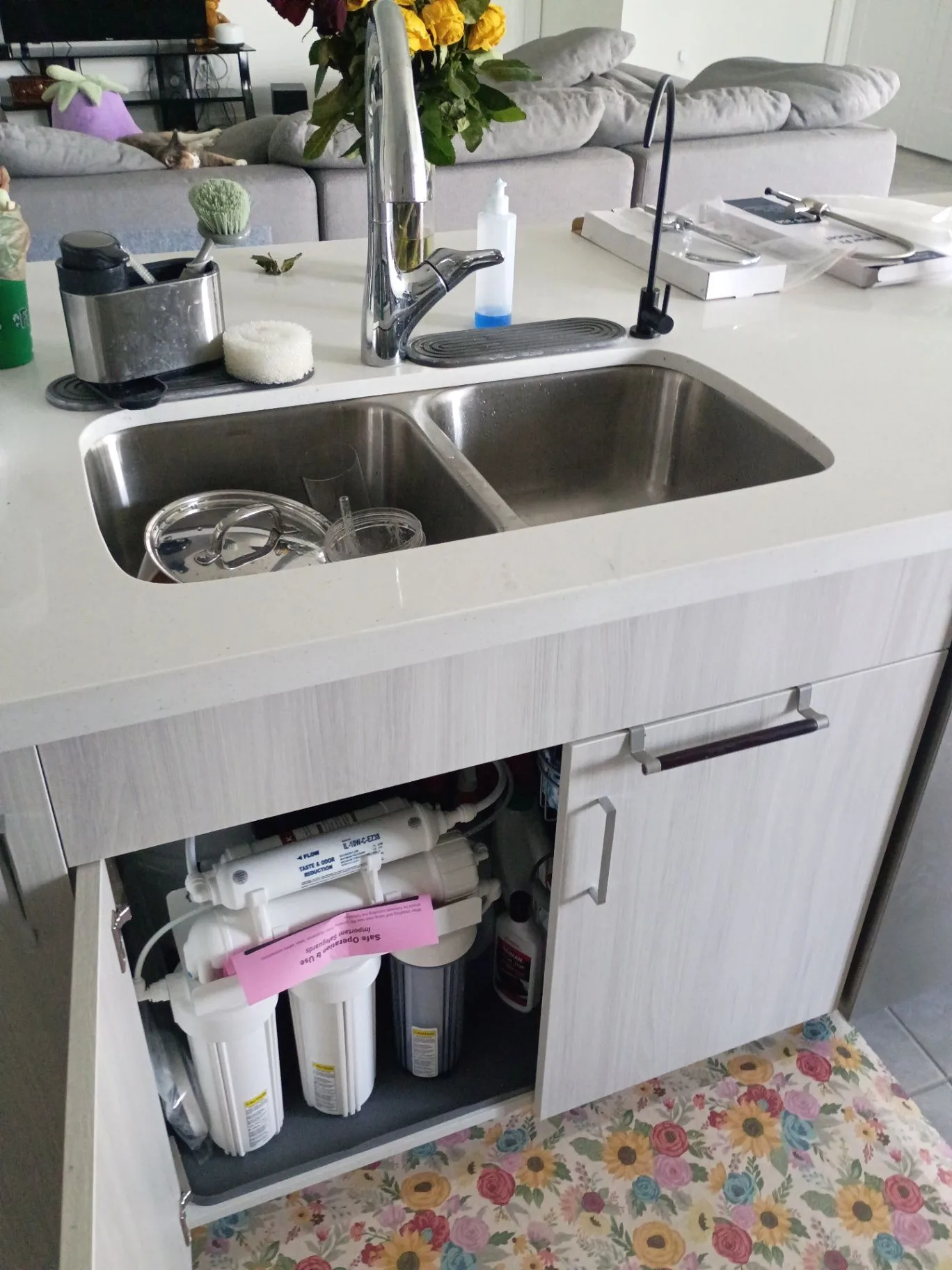 Under-sink reverse osmosis drinking-water system installed beneath a kitchen sink